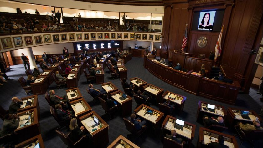 L.A. officials are about to focus anew on school safety this week following a debate in the Florida Legislature over the weekend. In this photo from late February, that state's lawmakers watch a slideshow of the Parkland shooting victims.