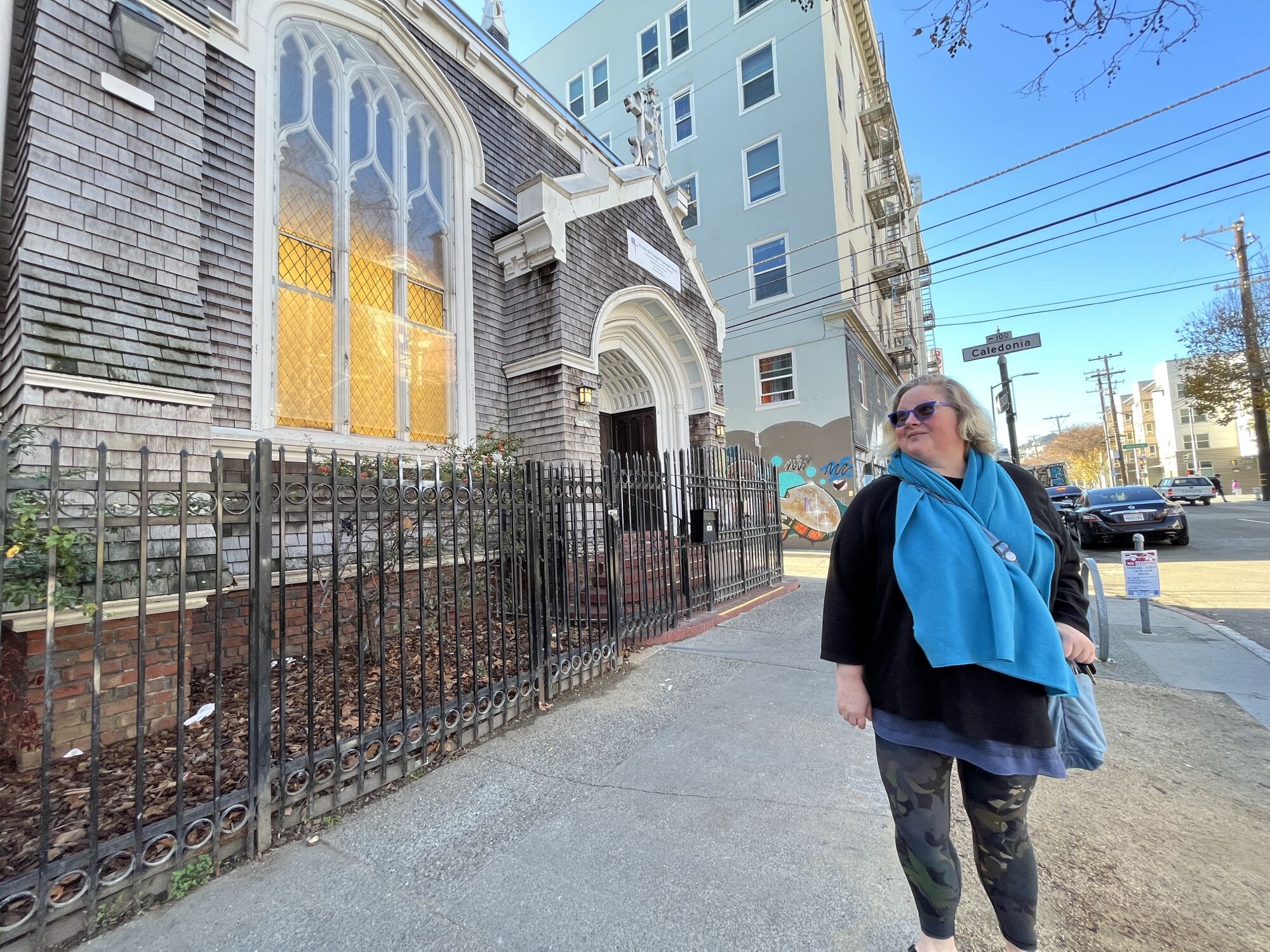 Lydia Bransten stands in front of St. John the Evangelist church in San Francisco's Mission district