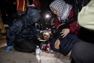 An injured person gets help at a pro-Palestinian encampment at UCLA late Tuesday, April 30, 2024.