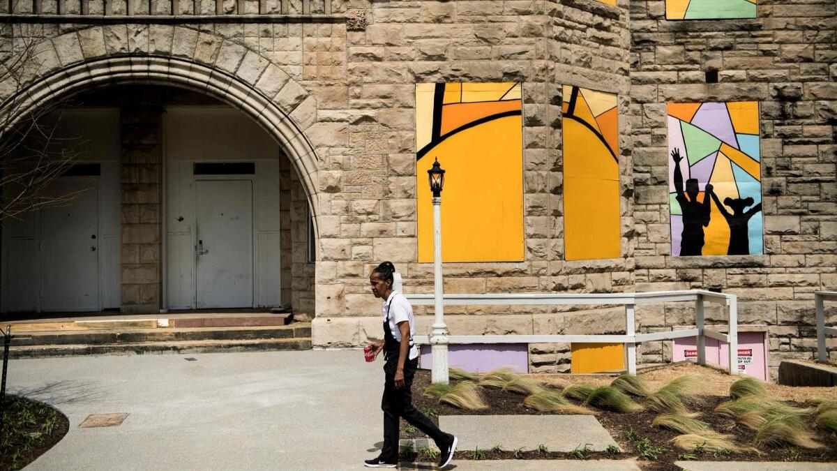 A woman walks past the historic Clayborn Temple in Memphis, Tenn.