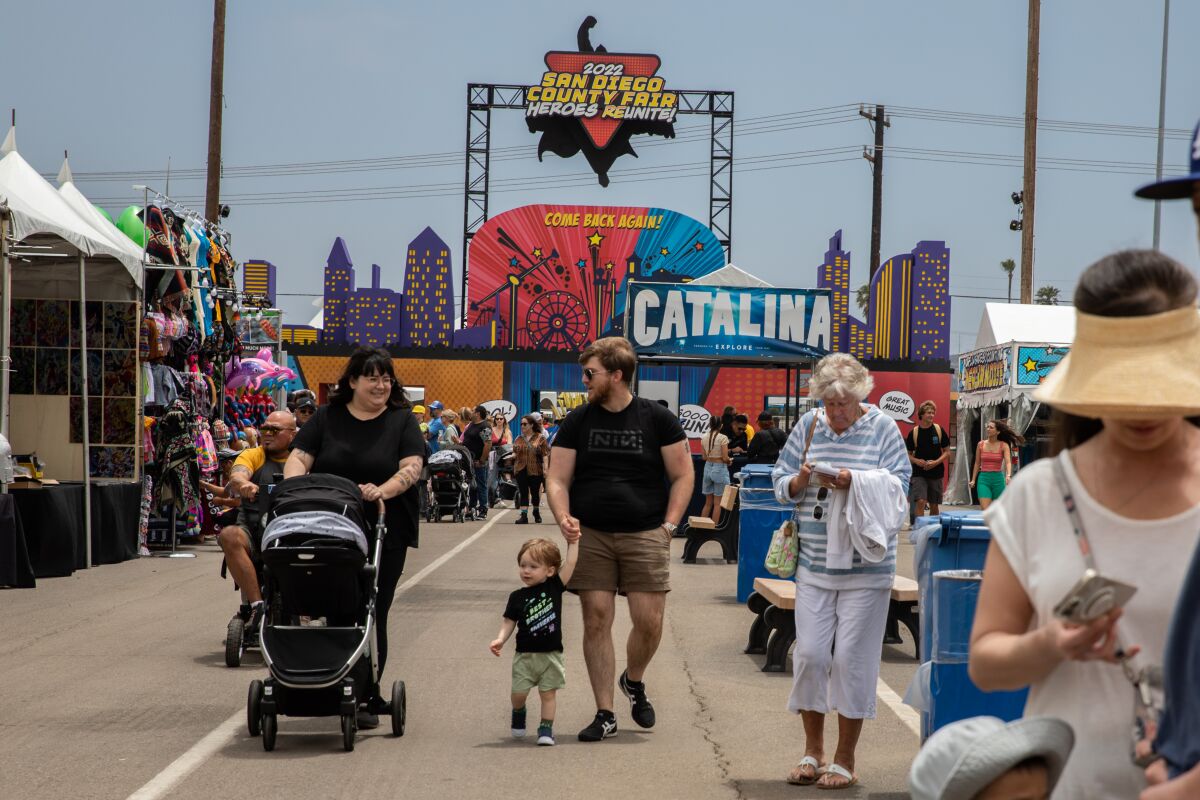 Attendees walk through the main entrance of the San Diego County Fair on opening day, Wednesday.
