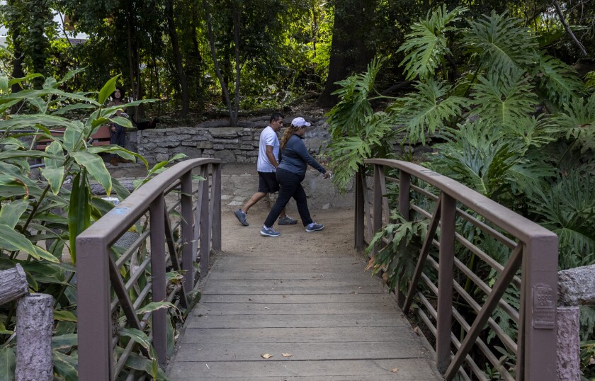 Visitors walk past a foot bridge in Griffith Park on the Fern Dell Nature Trail in August.