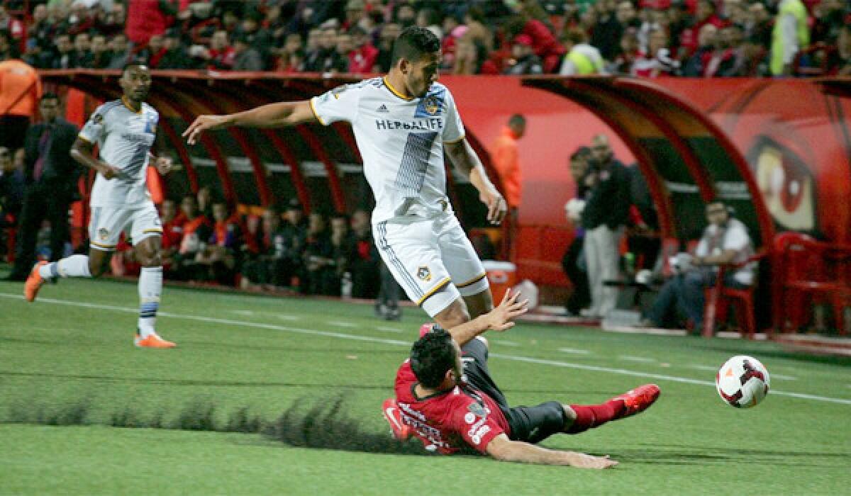 Mexican Xolos de Tijuana soccer team player Javier Gandolfi fights for the ball with Galaxy player Samuel Rosa during ar Concacaf Champions League match at the Caliente stadium in Tijuana, Mexico on March 18.