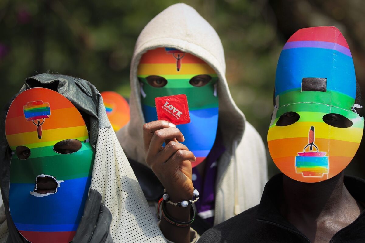 Masked Kenyan LGBT supporters at a protest against Uganda's anti-gay bill in front of the Ugandan High Commission in Nairobi, Kenya. Ugandan President Yoweri Museveni signed the bill into law Feb. 24.