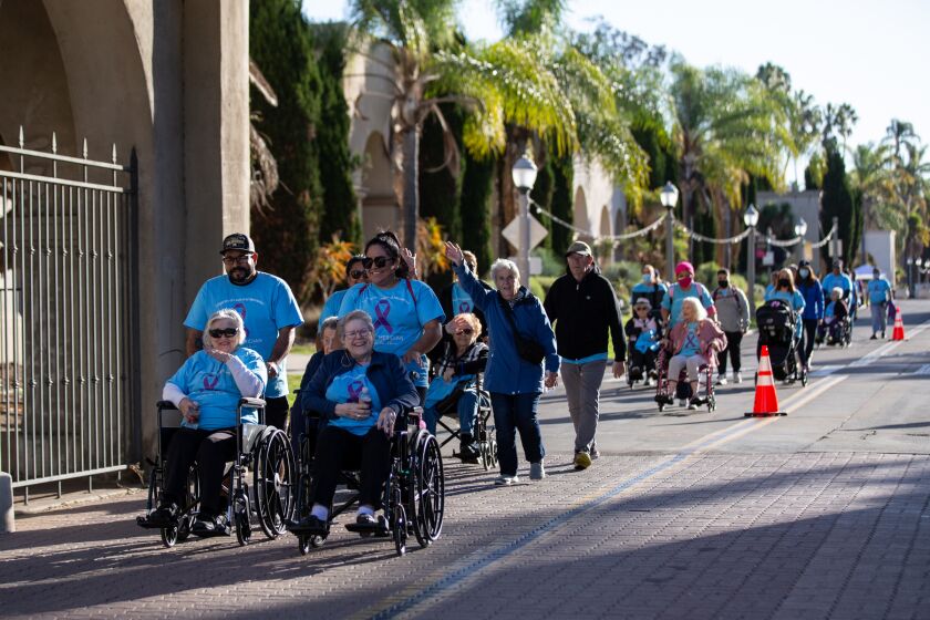 People participate in non-profit Alzheimer’s San Diego’s annual walk to support San Diegans living with dementia and their caregivers on Saturday, Oct. 16, 2021, at Balboa Park. Around 1,000 people participated in the event and raised over $400,000.