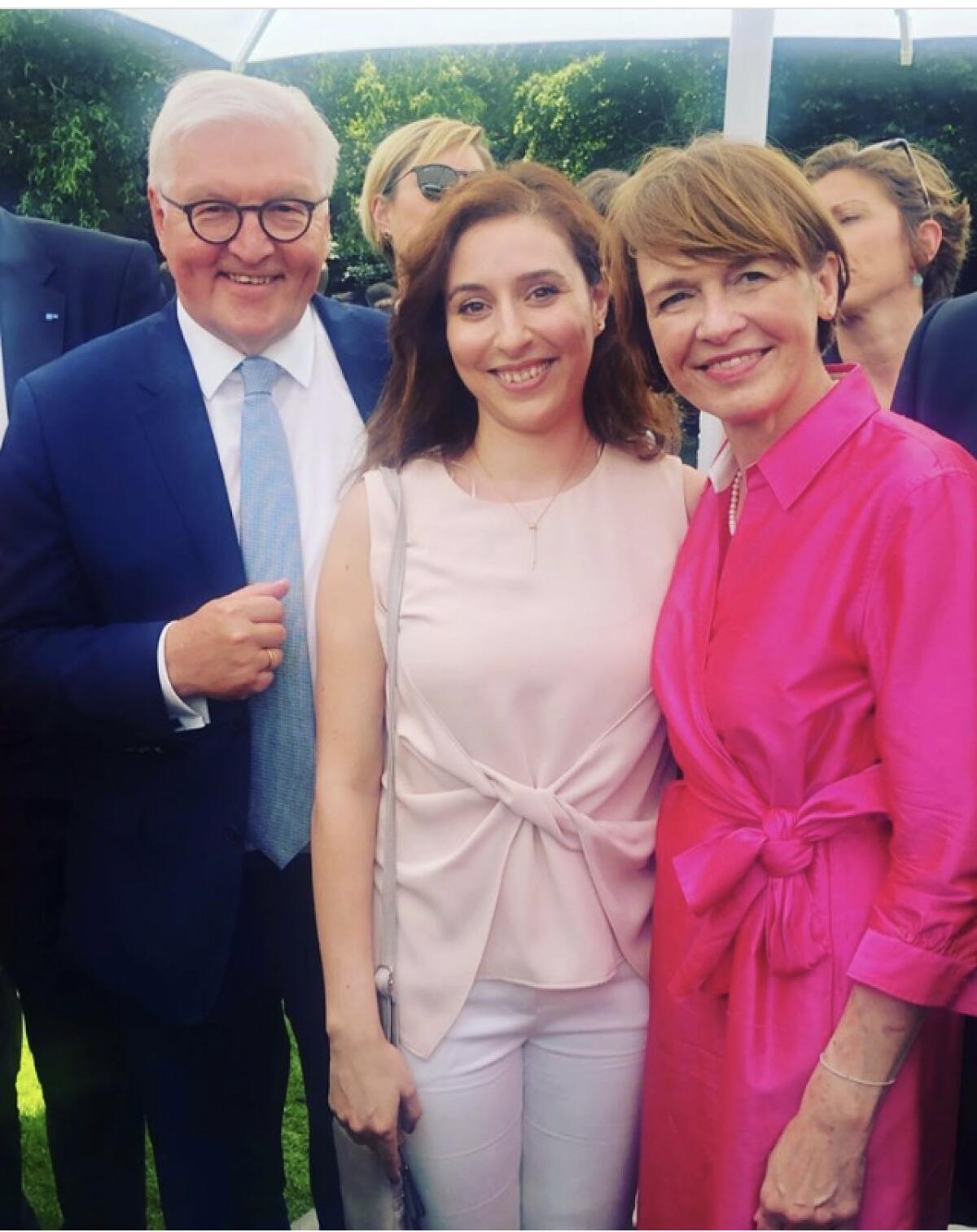 Rawan Al-Kurdi with German President Frank-Walter Steinmeier and his wife, Elke Budenbender, at an event 