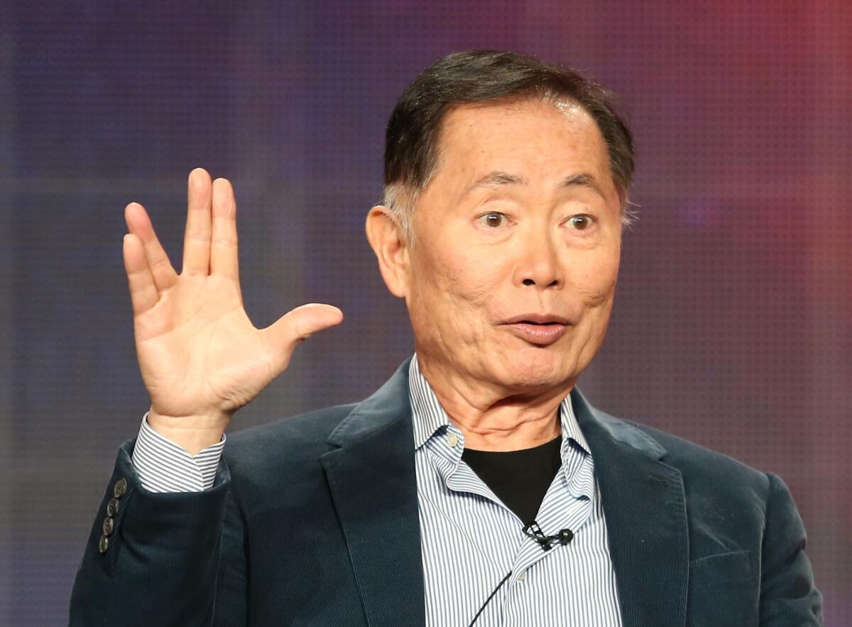 George Takei, author of "They Called Us Enemy," gives the Vulcan salute.