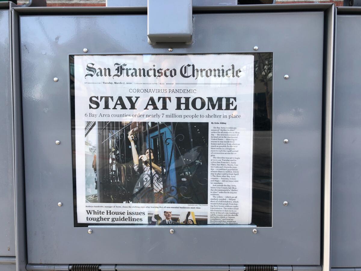 A newsstand displays the front page of the San Francisco Chronicle on Tuesday, March 17, 2020.