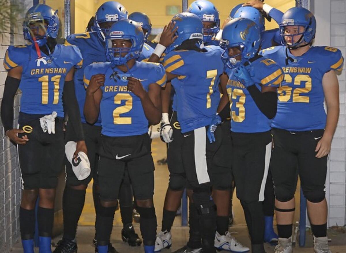 Crenshaw players prepare to take the field last week against Whittier Christian. 