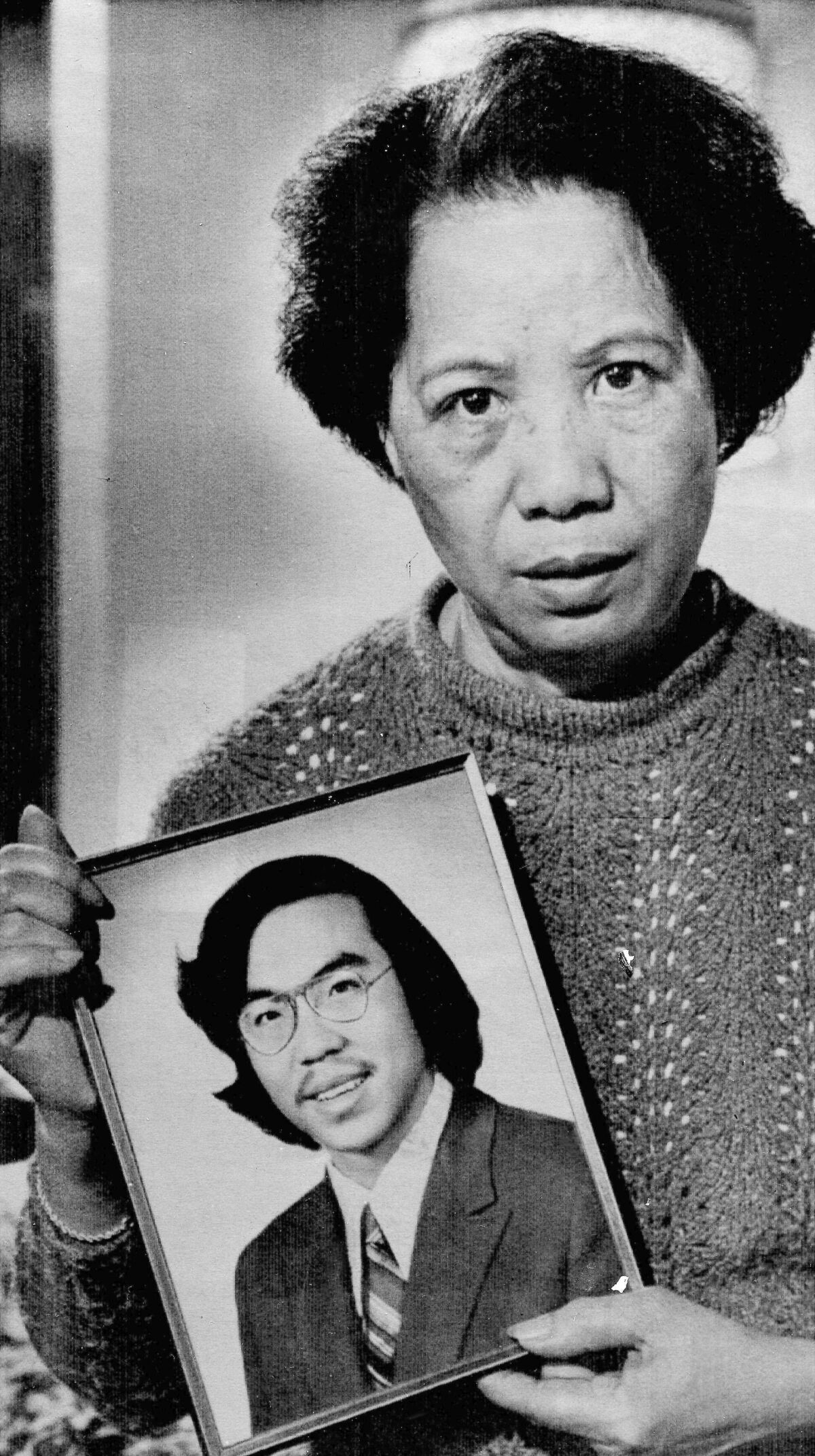 FILE - In this Nov. 2, 1983, photo, Lily Chin holds a photograph of her son Vincent, 27, who was beaten to death on June 23, 1982. Detroit is helping to honor Vincent Chin, a Chinese American man who was beaten to death 40 years ago by two white men who never served jail time. The Vincent Chin 40th Remembrance & Rededication begins Thursday, June 16, 2022, and focuses on civil rights efforts that started with his 1982 death. (AP Photo/Richard Sheinwald, File)