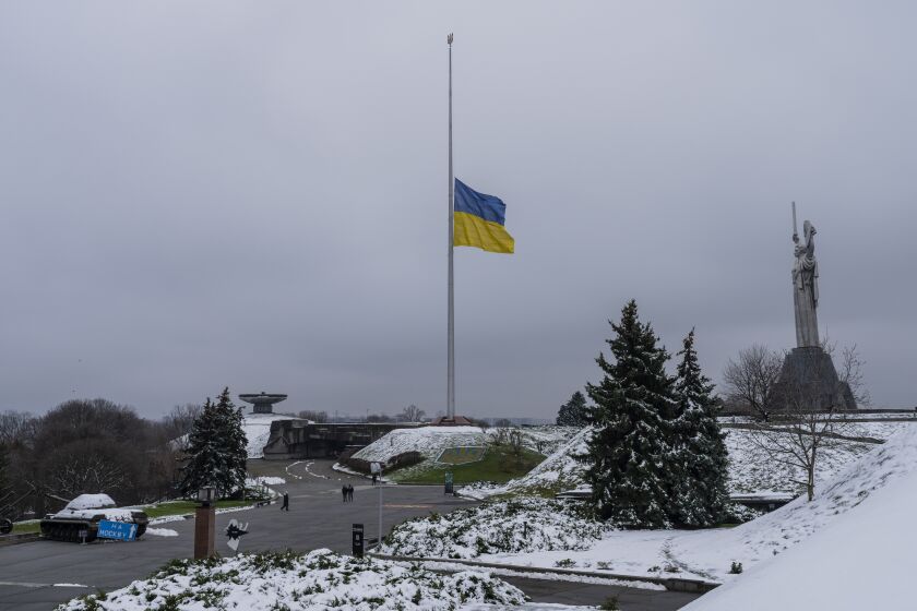 The Ukrainian flag flatters at half mast near the Ukrainian Motherland monument in Kyiv, Ukraine, Tuesday, Nov. 29, 2022. (AP Photo/Bernat Armangue)