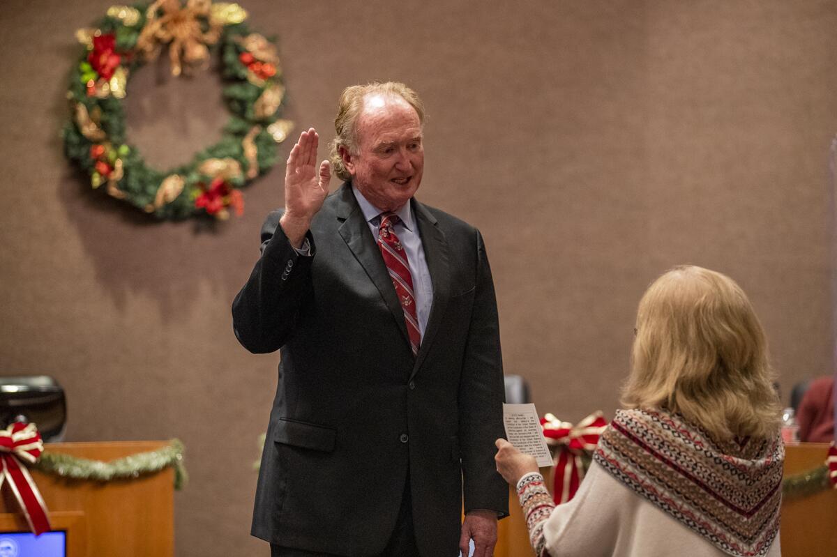 Mike Posey takes the oath of office for mayor pro tem during a Huntington Beach City Council meeting on Dec. 7, 2020.