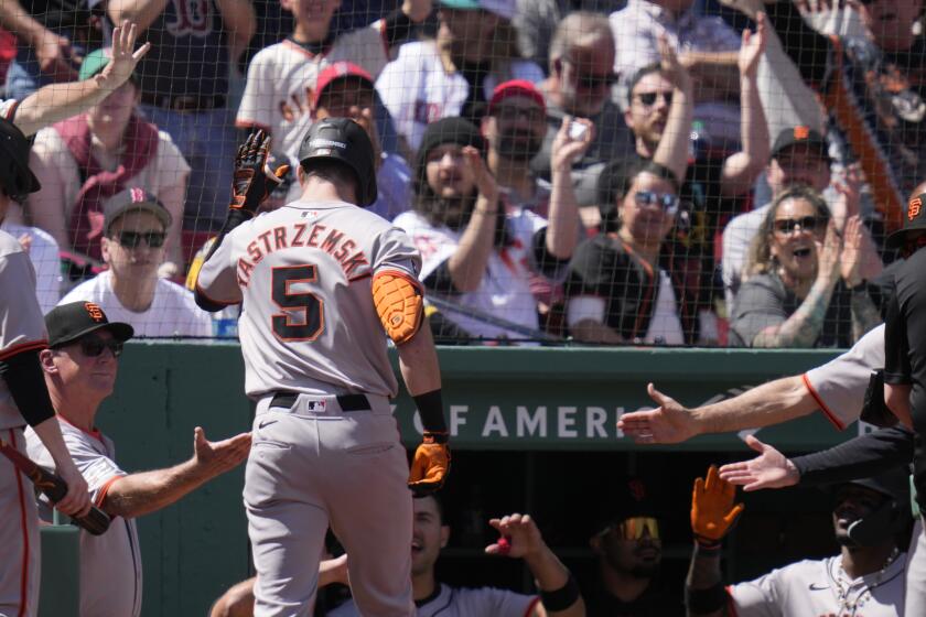 San Francisco Giants' Mike Yastrzemski (5) is congratulated after his solo home run during the third inning of a baseball game against the Boston Red Sox at Fenway Park, Thursday, May 2, 2024, in Boston. (AP Photo/Charles Krupa)