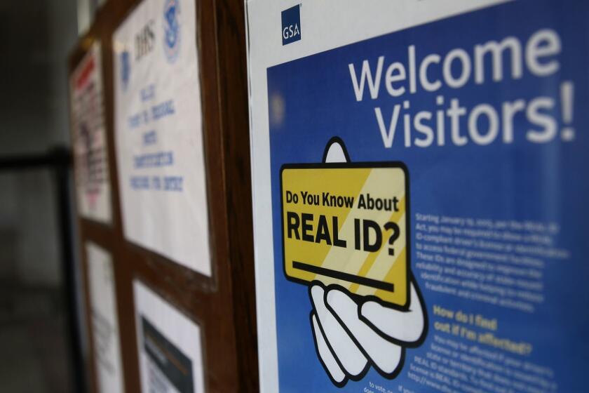 FILE - In this photo taken April 6, 2016, a sign at the federal courthouse in Tacoma, Wash., is shown to inform visitors of the federal government's REAL ID act, which requires state driver's licenses and ID cards to have security enhancements and be issued to people who can prove they're legally in the United States. Lawmakers in Washington state are now trying to bring the state in compliance with the law, and if state-issued identification cards and licenses are not changed, residents may have to produce additional forms of ID when boarding domestic flights at U.S. airports beginning in January, 2018. (AP Photo/Ted S. Warren, file)