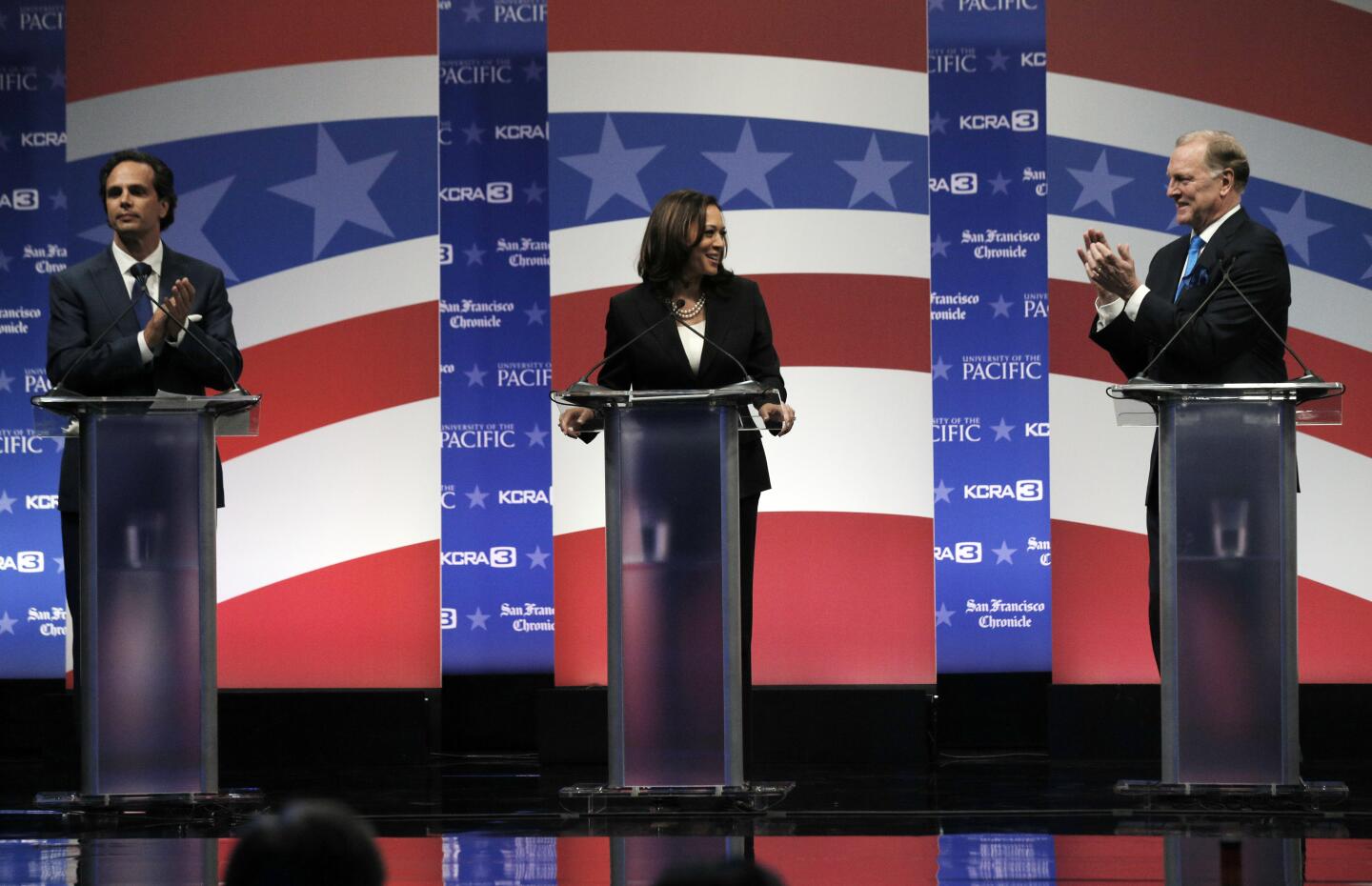 April 25, 2016: Tom Del Beccaro, left, and Duf Sundheim applaud California Atty. Gen. Kamala Harris at a U.S. Senate debate.