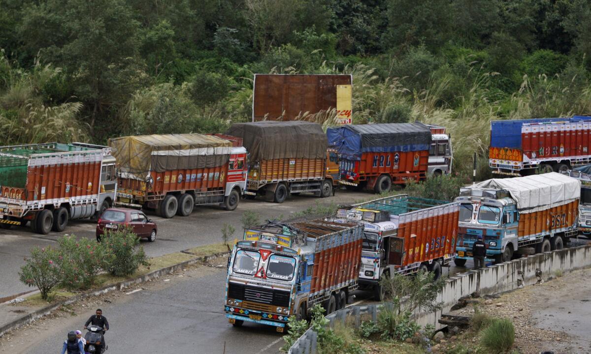 Stranded trucks stand in a line at the Jammu-Srinagar highway on the outskirts of Jammu, India, on Monday.
