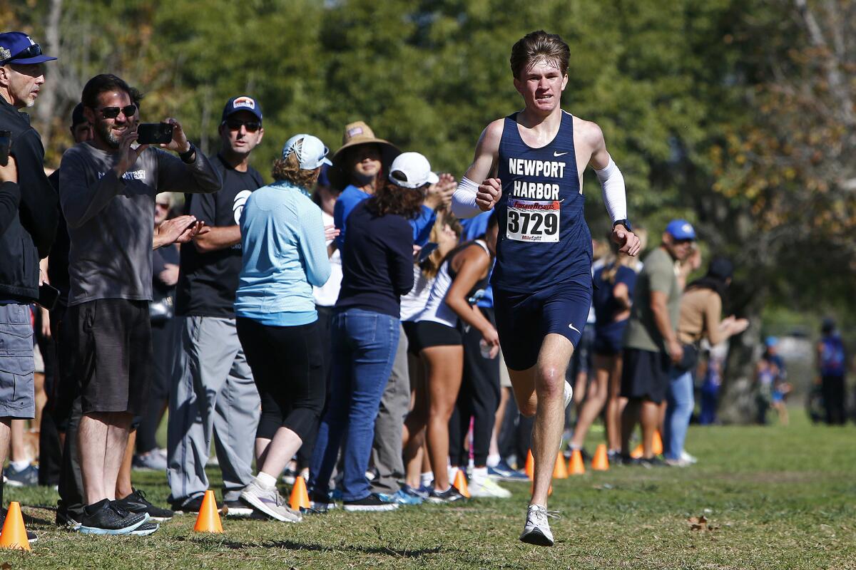 Newport Harbor's Kenny Wanlass approaches the finish line in the Sunset Conference cross-country finals.