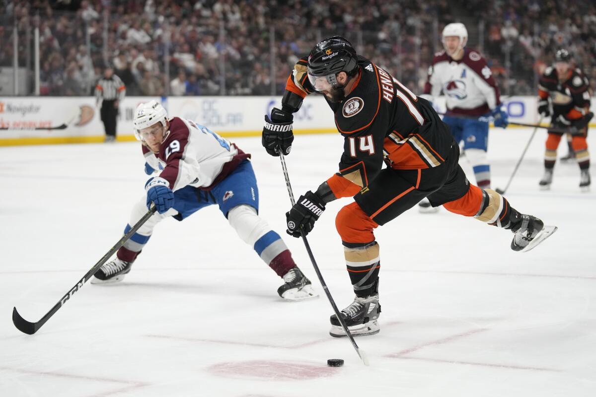 Ducks center Adam Henrique shoots against Colorado Avalanche center Nathan MacKinnon.