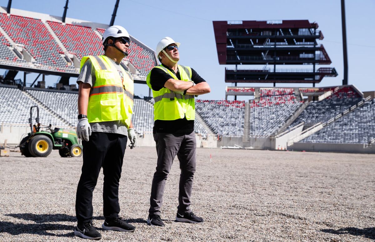 San Diego State head coach Brady Hoke (right) checks out Snapdragon Stadium with director of football operations Ruben Pena.