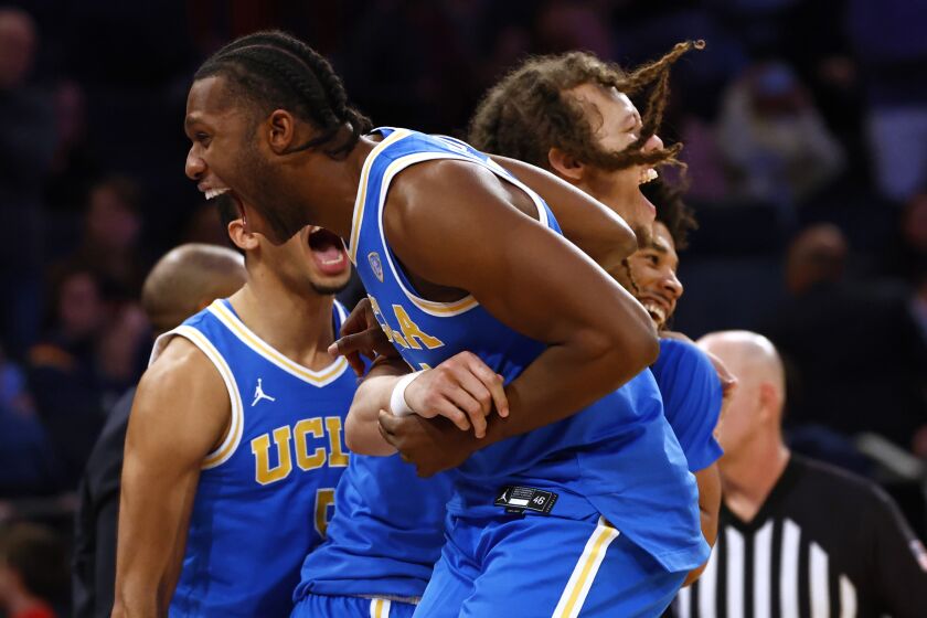 NEW YORK, NY - DECEMBER 17: David Singleton #34 and Mac Etienne #12 of the UCLA Bruins celebrate after defeating the Kentucky Wildcats 63-53 in the CBS Sports Classic at Madison Square Garden on December 17, 2022 in New York City. (Photo by Rich Schultz/Getty Images)