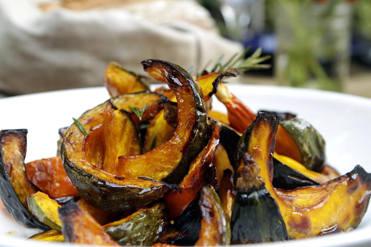 Roasted kabocha squash with a sprig of rosemary.