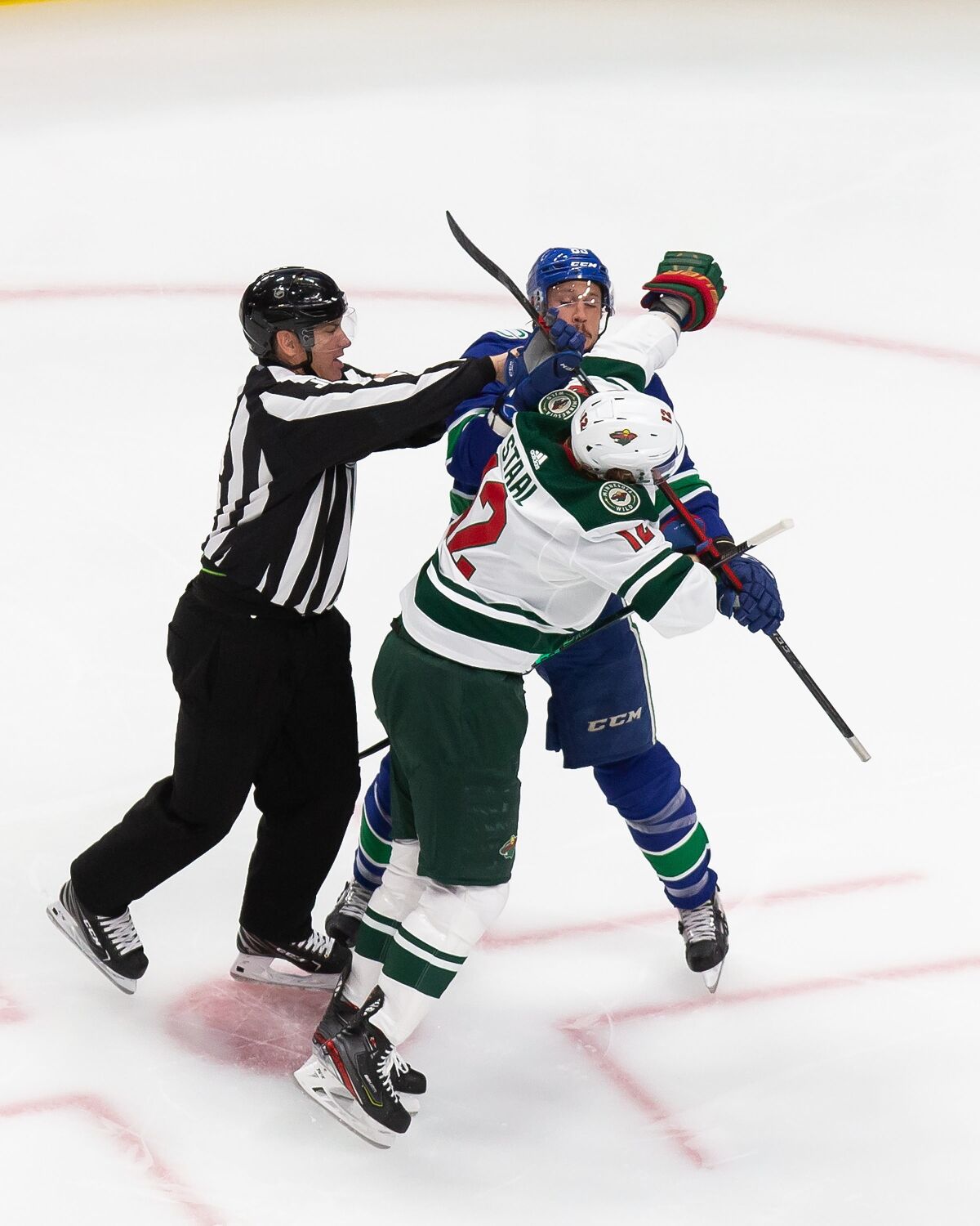 Minnesota Wild's Eric Staal (12) battles against Vancouver Canucks' Jay Beagle (83) during the first period of an NHL hockey playoff game Tuesday, Aug. 4, 2020 in Edmonton, Alberta. (Codie McLachlan/The Canadian Press via AP)