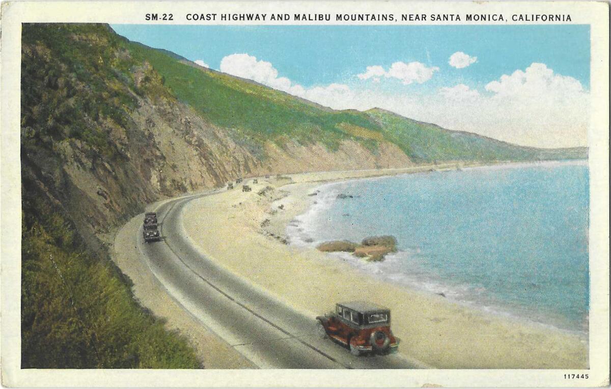 A stretch of Coast Highway, with old cars, cliffs and the blue Pacific