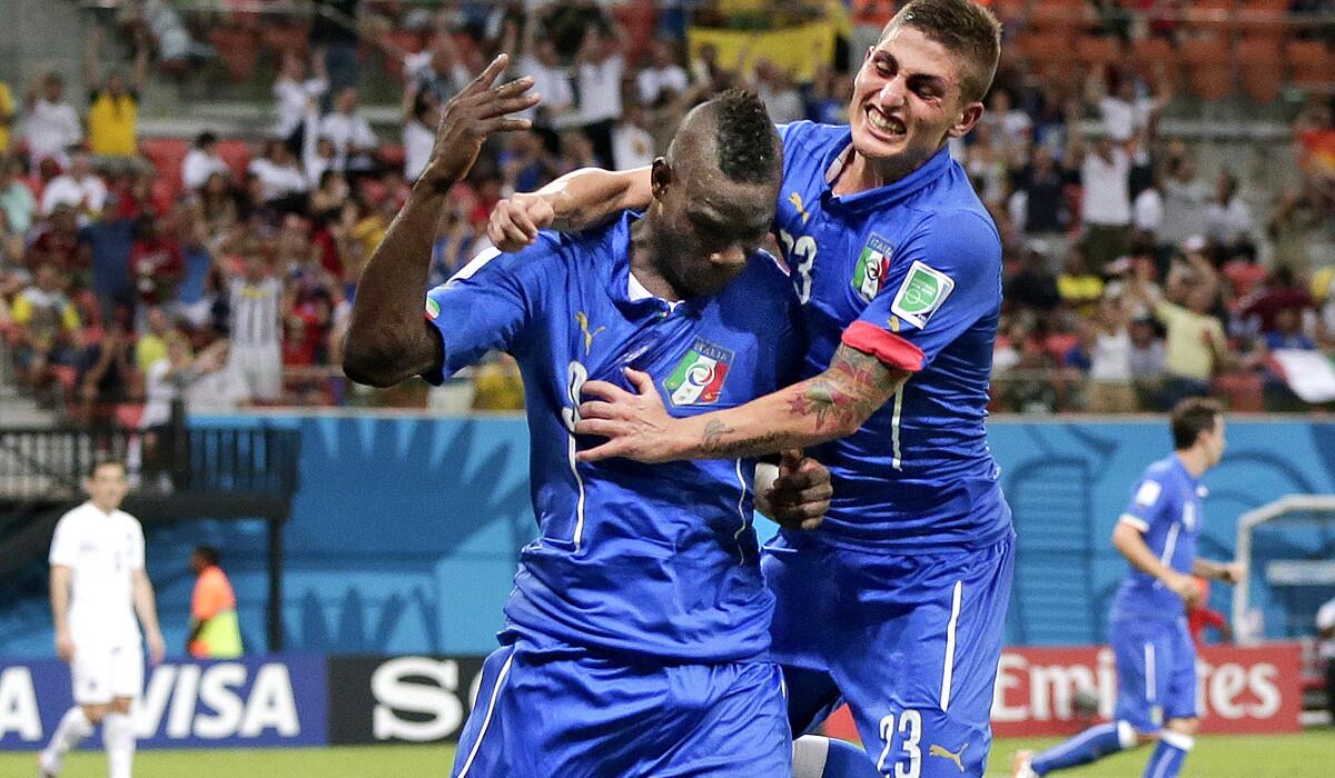 Italy striker Mario Balotelli (9) celebrates with teammate Marco Verratti after scoring a goal to give his team a 2-1 lead over England in a World Cup Group D opener on Saturday at the Arena da Amazonia in Manaus, Brazil.