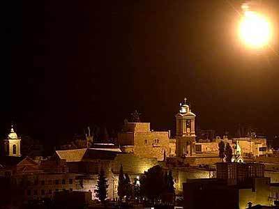 An Israeli flare illuminates the Church of Nativity in the West Bank town of Bethlehem on Wednesday. Many of the more than 200 people who reportedly took refuge inside the church when Israeli defense forces entered the town are suspected to be Palestinian gunmen. The Israeli Army continued in their search for weapons and suspected Palestinian terrorists in the area in what is being called "Operation Defensive Shield."