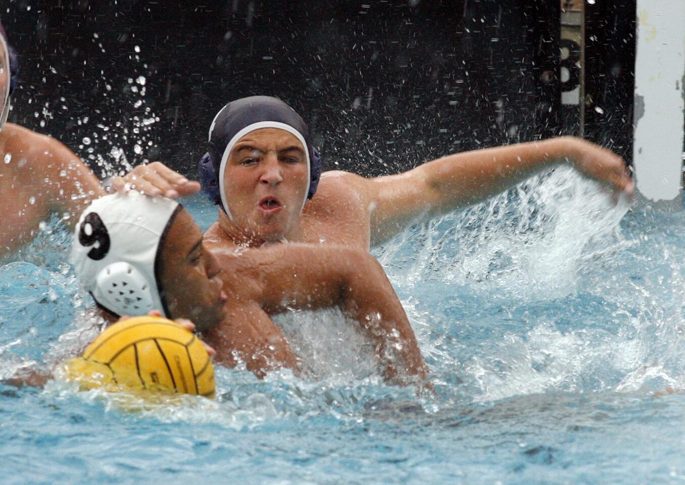 The defense of Crescenta Valley's Alexander Trimis pushes onto Hoover's Ryan Moguel in a Pacific League boys water polo match at Crescenta Valley High School on Thursday, October 11, 2012.