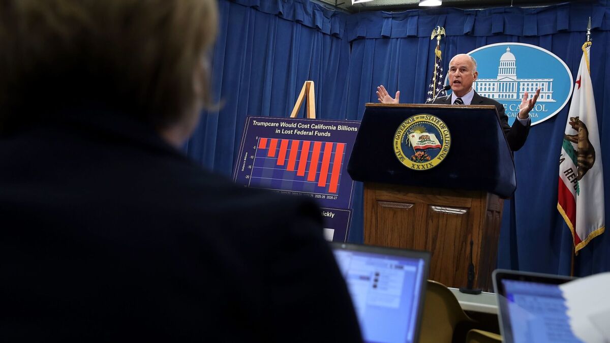 Gov. Jerry Brown speaks to reporters about his revised state budget.