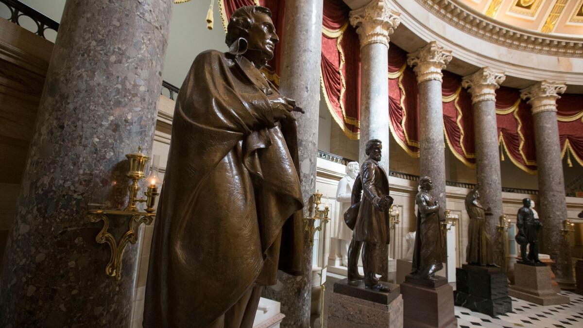 A statue (L) of Jefferson Davis, president of the Confederate states of America, stands among other statues in Statuary Hall on Capitol Hill in Washington on Aug. 18.