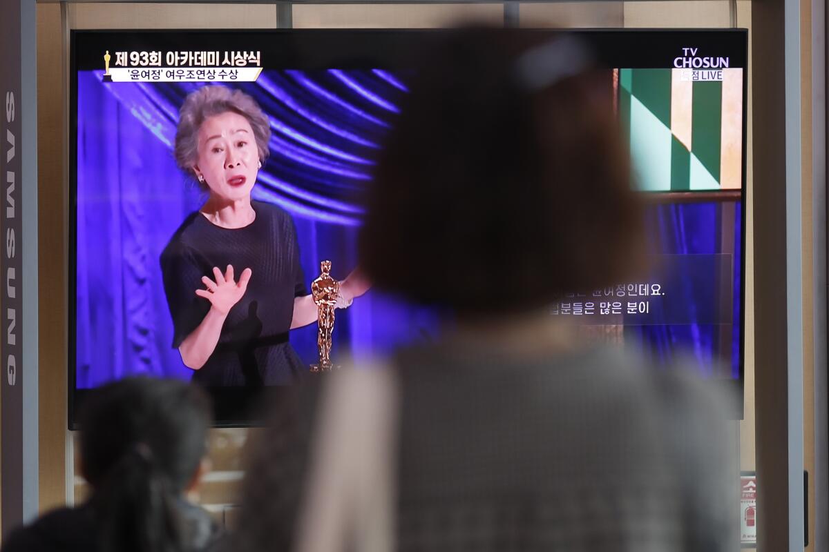 Passersby in Seoul watch live broadcast of Oscars as Yuh-Jung Youn makes her acceptance speech