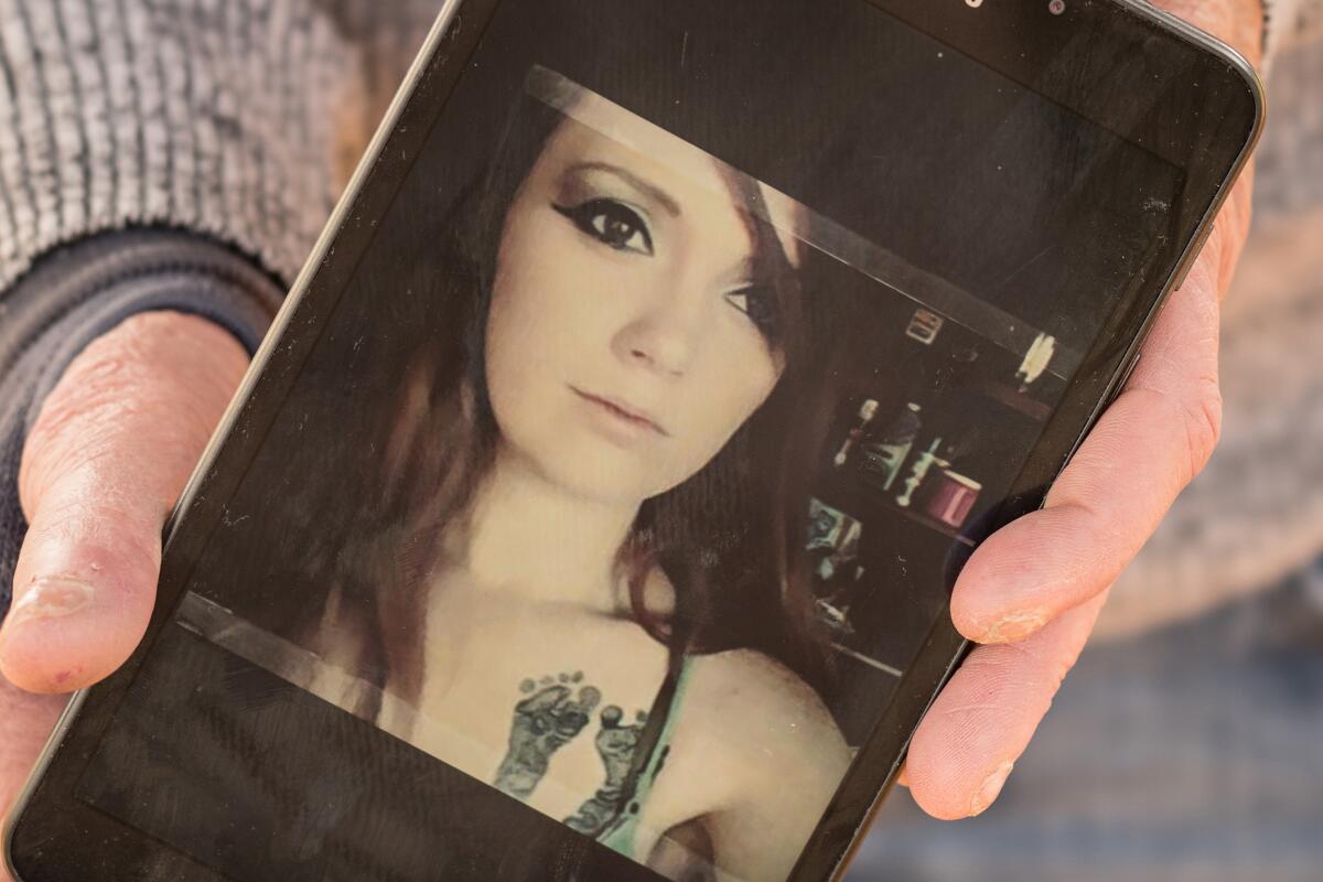 Jennifer Hernandez shows a picture of daughter Chelsea Becker on her phone.