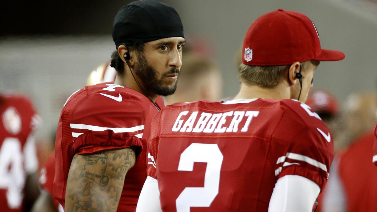 San Francisco 49ers quarterbacks Colin Kaepernick and Blaine Gabbert talk on the sideline during an Aug. 26 preseason game against the Green Bay Packers at Levi's Stadium in Santa Clara, Calif.