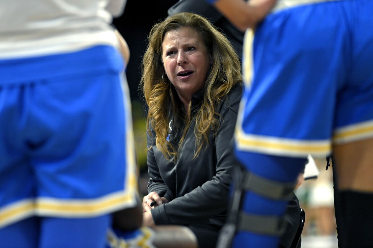 UCLA coach Cori Close talks to her team during a timeout 