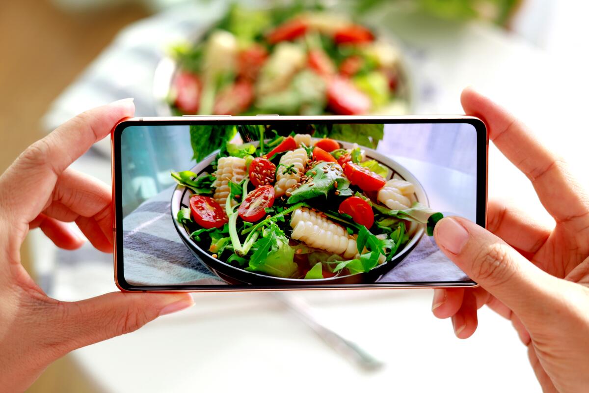 Smartphone captures photos of a homemade salad