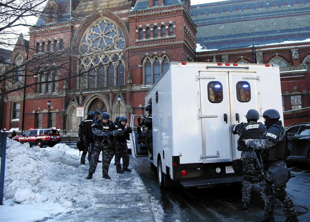 SWAT team officers arrive at a building at Harvard University in Cambridge, Mass. Four buildings were evacuated after campus police received a report that explosives may have been put inside.