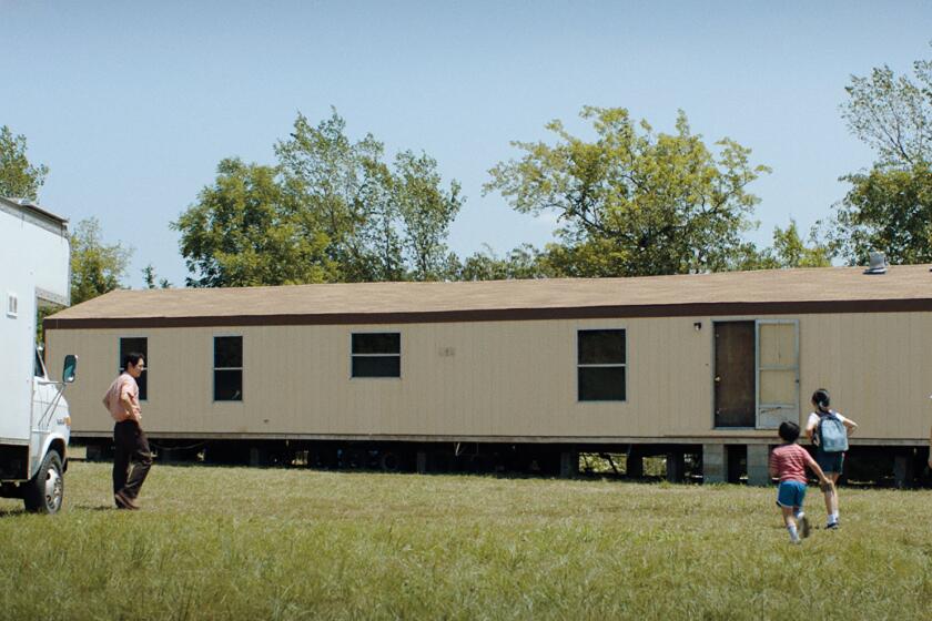 A still from "Minari" shows the family driving up to their future mobile home