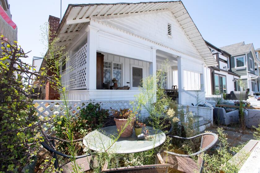 Weeds fill the yard of a home on Balboa Boulevard. 