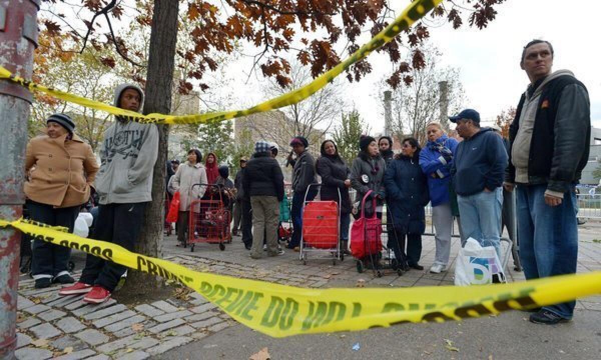 People wait in line to receive food and supplies at a food donation site to help those in areas without power as the city tries to recover from the after effects of Hurricane Sandy in New York.