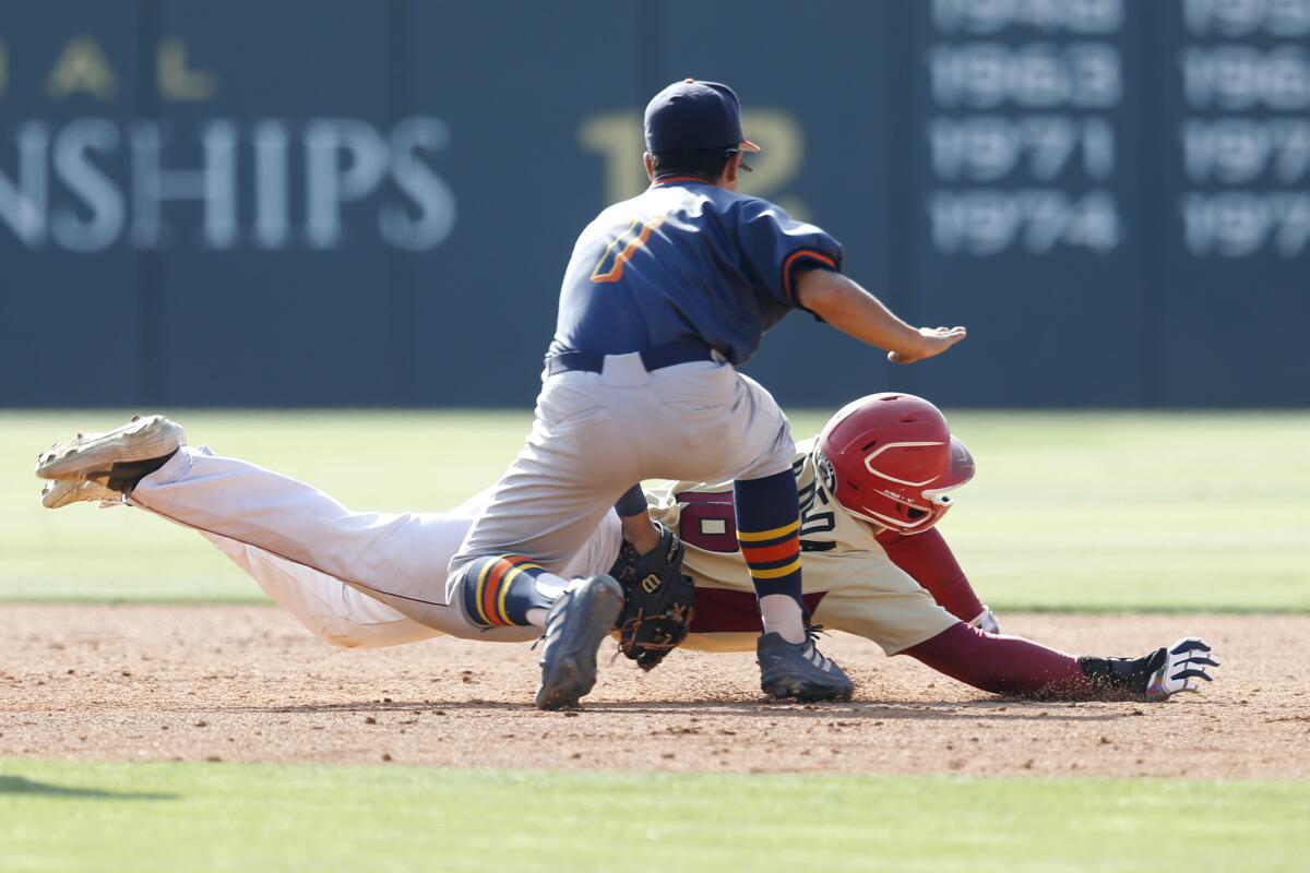 Chatsworth shortstop Barry Menjivar tags out Roosevelt's Daniel Olmeda in the bottom of the fifth inning.