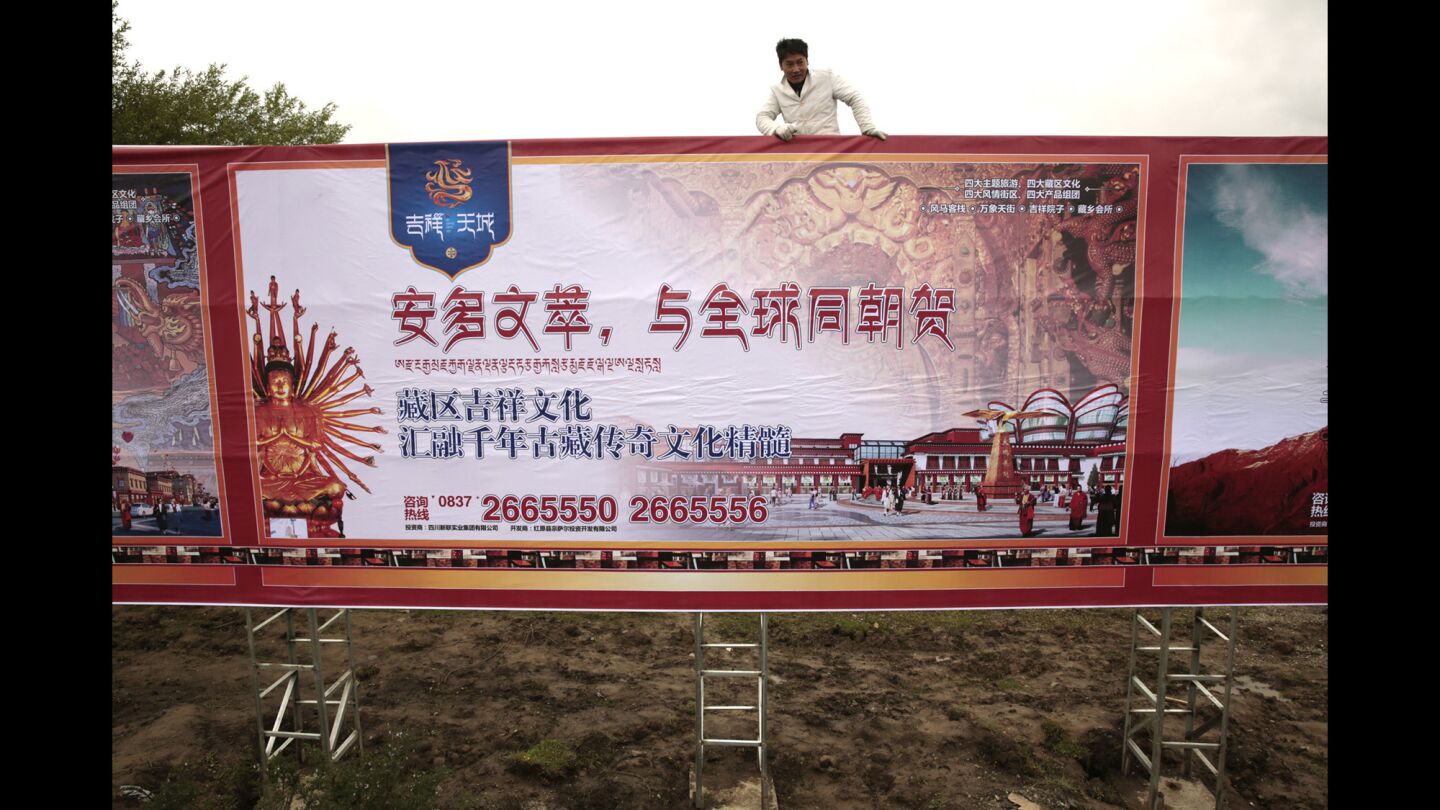 In Aba, advertisements tout a new housing development. The Chinese government is urging nomads to settle in communities where they have access to housing, healthcare and other services.