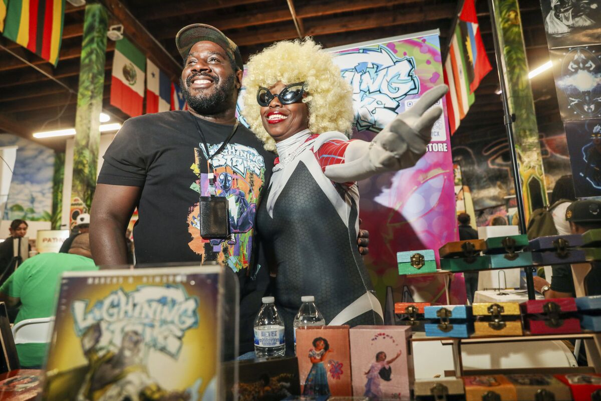 Marcus Newsome and Khanya at their display booth at the San Diego Black Com!x Day 2023 at The WorldBeat Cultural Center.