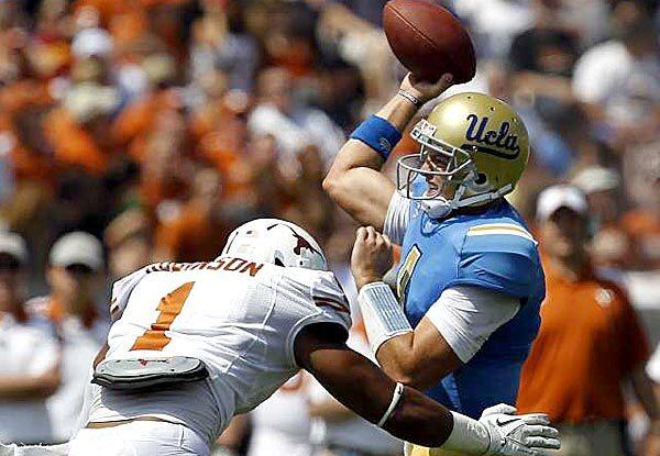 UCLA quarterback Kevin Prince is rushed into a pass by Texas linebacker Keenan Robinson, resulting in an interception in the first quarter Saturday at the Rose Bowl.