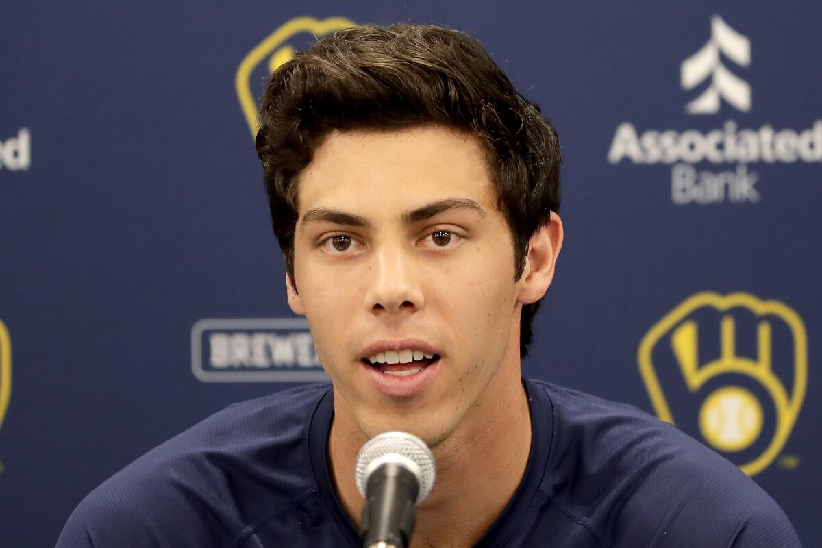 FILE - In this March 6, 2020, file photo, Milwaukee Brewers' Christian Yelich speaks after the Brewers announced his multi-year contract extension at the team's spring training facility in Phoenix. Yelich acknowledges he benefited from fortunate timing in how he handled his contract negotiations. The Brewers held the March 6 news conference to announce that the 2018 NL MVP had agreed to a nine-year, $215 million contract. Spring training was halted due less than a week later due to the coronavirus. (AP Photo/Matt York, File)