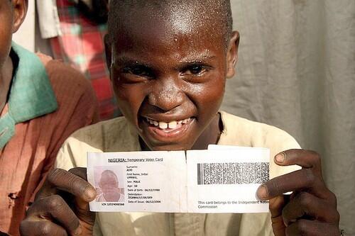 An underage Nigerian voter brandishes his voter registration card while waiting to cast his ballot in the presidential elections at a rural polling station in northern Nigeria on April 21, 2007. Despite looking not more than 10 years old, his voter registration card gives his age as 18. Electoral malpractice appeared widespread with cases of rampant vote rigging, incompetence and violence reported across the country.