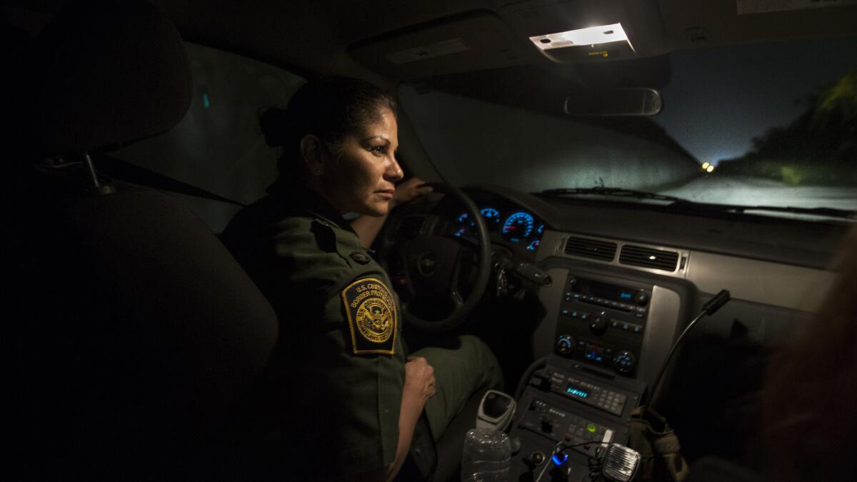 U.S. Border Patrol Agent Marlene Castro keeps an eye out for drug smugglers and migrants illegally crossing the Rio Grande in Hidalgo, Texas.