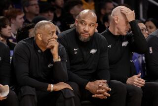 LOS ANGELES, CA - APRIL 7, 2024: Lakers head coach Darvin Ham, middle, sits on the bench.