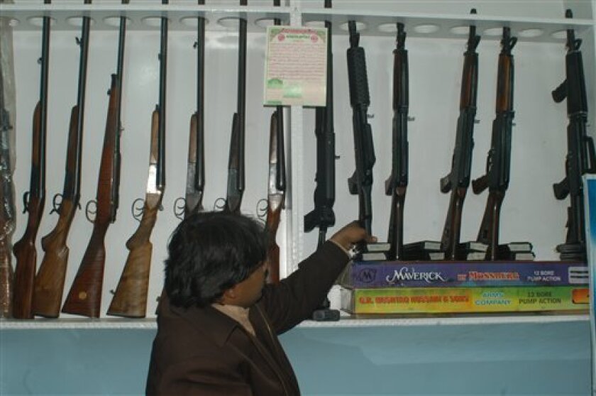 In this image taken on Jan . 20, 2010, A Pakistani arms merchant arranges assault rifles in a shop in Quetta, Pakistan. If Afghan Taliban fighters and their top leaders are roaming around this remote part of Pakistan as the U.S. alleges, the police chief here says he hasn't seen them. (AP Photo/Arshad Butt)